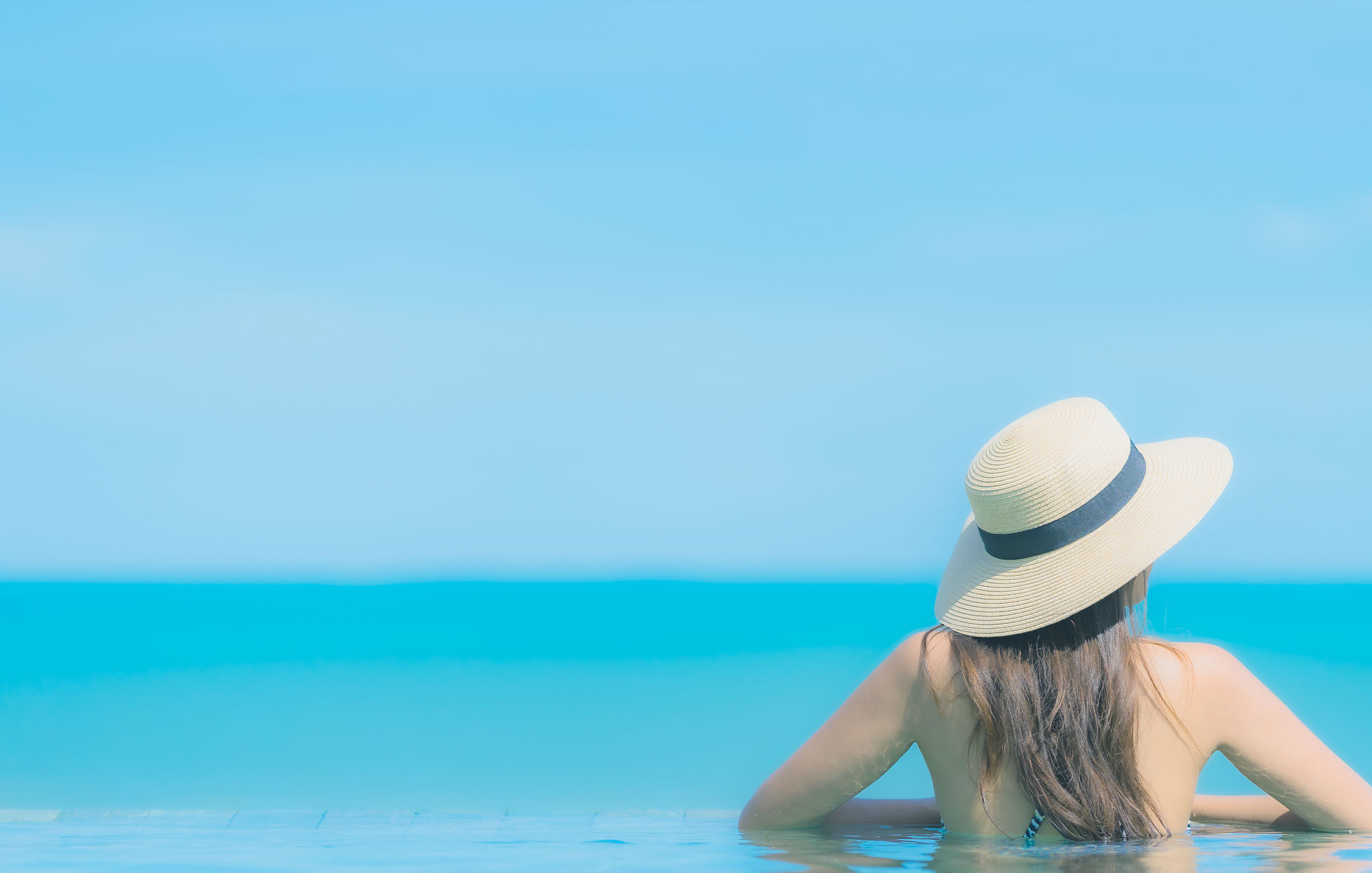Woman in hat looking at horizon (model)